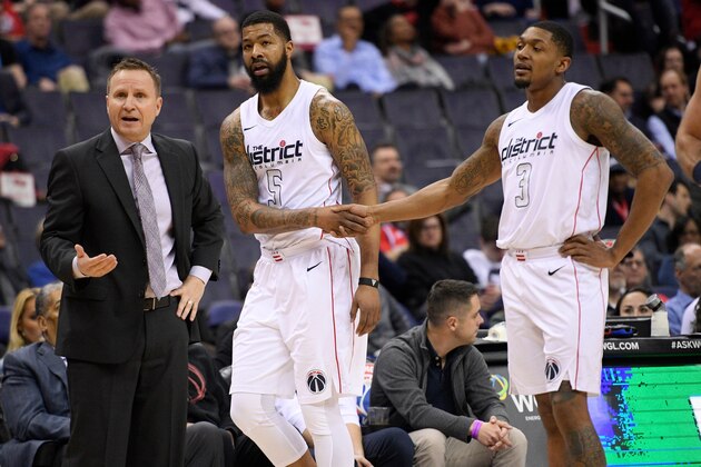 Washington Wizards forward Markieff Morris (5) shakes hands with guard Bradley Beal (3) after Morris was charged with two technical fouls and ejected during the first half of the team's NBA basketball game against the Atlanta Hawks, Friday, April 6, 2018, in Washington. At left is Wizards coach Scott Brooks. (AP Photo/Nick Wass) Washington Wizards forward Markieff Morris (5) shakes hands with guard Bradley Beal (3) after Morris was charged with two technical fouls and ejected during the first half of the team's NBA basketball game against the Atlanta Hawks, Friday, April 6, 2018, in Washington. At left is Wizards coach Scott Brooks. (AP Photo/Nick Wass)