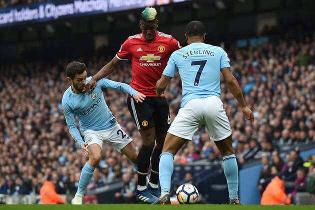 Manchester United's French midfielder Paul Pogba (C) vies with Manchester City's Portuguese midfielder Bernardo Silva (L) and Manchester City's English midfielder Raheem Sterling during the English Premier League football match between Manchester City and Manchester United at the Etihad Stadium in Manchester, north west England, on April 7, 2018. / AFP PHOTO / PAUL ELLIS / RESTRICTED TO EDITORIAL USE. No use with unauthorized audio, video, data, fixture lists, club/league logos or 'live' services. Online in-match use limited to 75 images, no video emulation. No use in betting, games or single club/league/player publications.  /         (Photo credit should read PAUL ELLIS/AFP/Getty Images)