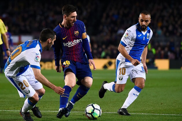Barcelona's Argentinian forward Lionel Messi (C) challenges Leganes' Moroccan forward Nabil El Zhar and Leganes' Spanish defender Joseba Zaldua (L) during the Spanish league football match between Barcelona and Leganes at the Camp Nou stadium in Barcelona on April 7, 2018. / AFP PHOTO / Josep LAGO        (Photo credit should read JOSEP LAGO/AFP/Getty Images)