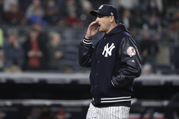 New York Yankees manager Aaron Boone motions to the dugout during a visit to the mound during the ninth inning of a baseball game against the Baltimore Orioles, Friday, April 6, 2018, in New York. (AP Photo/Julie Jacobson)