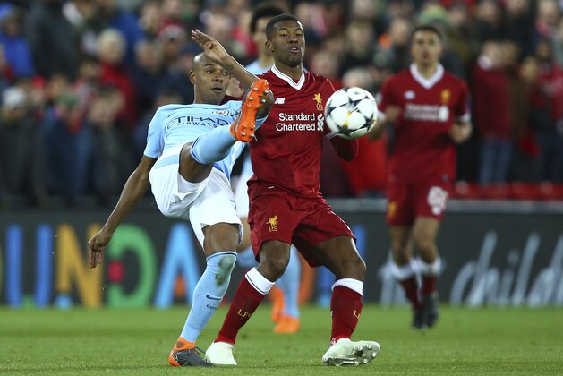 Manchester City's Fernandinho, left, competes for the ball with Liverpool's Georginio Wijnaldum during the Champions League quarter final first leg soccer match between Liverpool and Manchester City at Anfield stadium in Liverpool, England, Wednesday, April 4, 2018. (AP Photo/Dave Thompson)