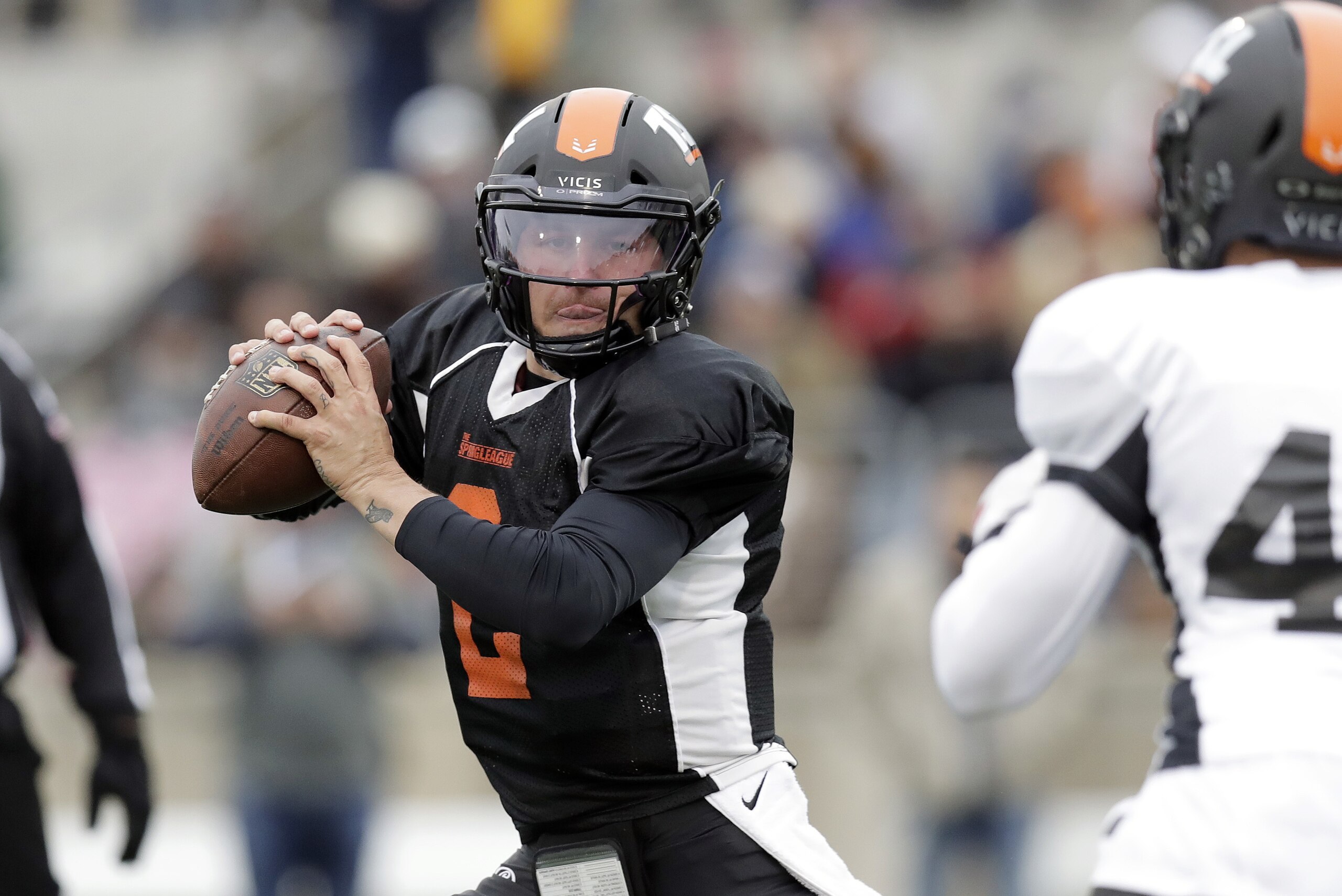Former Heisman Trophy-winning quarterback Johnny Manziel (2) scrambles as he looks to throw during a developmental Spring League football game, Saturday, April 7, 2018, in Austin, Texas. Manziel is hoping to impress NFL scouts in his bid to return to the league. (AP Photo/Eric Gay)