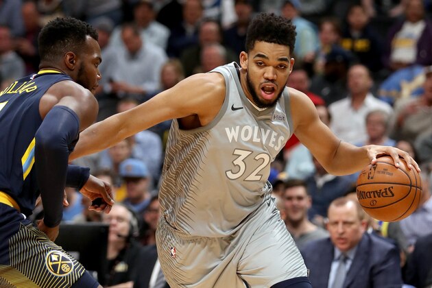 DENVER, CO - APRIL 05: Karl-Anthony Towns #32 of the Minnesota Timberwolves drives to the basket against Paul Millsap #4 of the Denver Nuggets at the Pepsi Center on April 5, 2018 in Denver, Colorado. NOTE TO USER: User expressly acknowledges and agrees that, by downloading and or using this photograph, User is consenting to the terms and conditions of the Getty Images License Agreement. (Photo by Matthew Stockman/Getty Images)