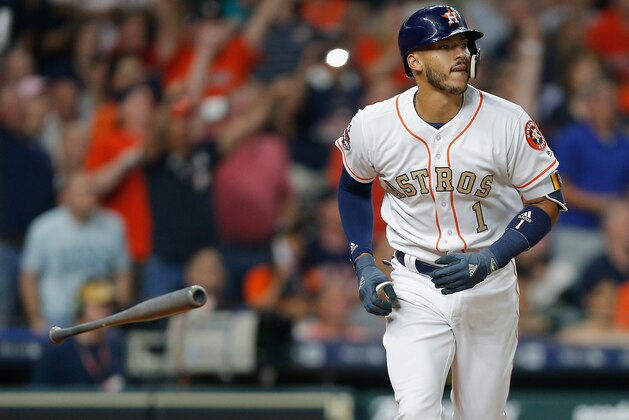 HOUSTON, TX - APRIL 03:  Carlos Correa #1 of the Houston Astros hits a sacrifice fly in the third inning against the Baltimore Orioles at Minute Maid Park on April 3, 2018 in Houston, Texas.  (Photo by Bob Levey/Getty Images)