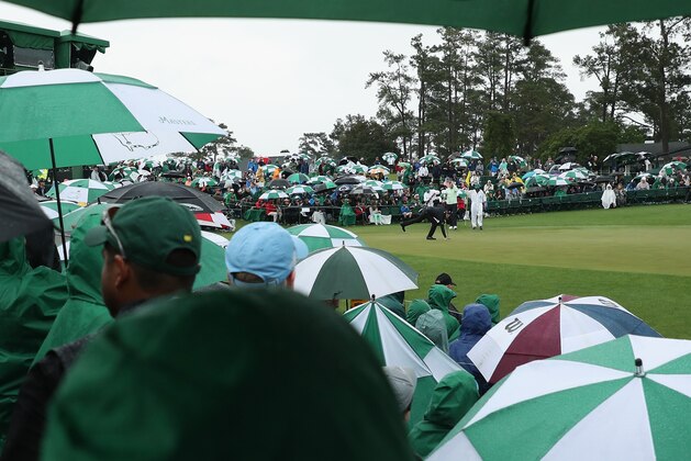 AUGUSTA, GA - APRIL 07:  Fans watch Jimmy Walker of the United States putt from under umbrellas during the third round of the 2018 Masters Tournament at Augusta National Golf Club on April 7, 2018 in Augusta, Georgia.  (Photo by Patrick Smith/Getty Images)