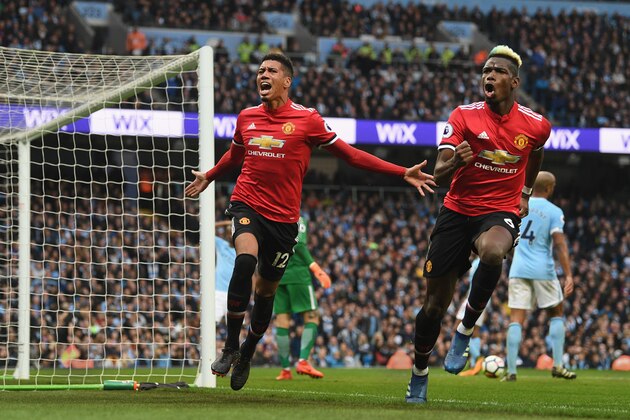 MANCHESTER, ENGLAND - APRIL 07: Chris Smalling of Manchester United celebrates scoring his side's third goal with Paul Pogba during the Premier League match between Manchester City and Manchester United at Etihad Stadium on April 7, 2018 in Manchester, England. (Photo by Michael Regan/Getty Images)