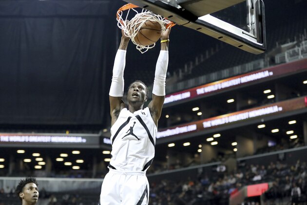 The White Team's Emmitt Williams #5 dunks against The Black Team during the Jordan Brand Classic high school basketball game, Sunday, April 8, 2018, in Brooklyn. (AP Photo/Gregory Payan)