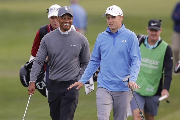 Tiger Woods, left, talks with Jordan Spieth as they approach the 17th green during the first round of the Valspar Championship golf tournament Thursday, March 8, 2018, in Palm Harbor, Fla. (AP Photo/Mike Carlson)