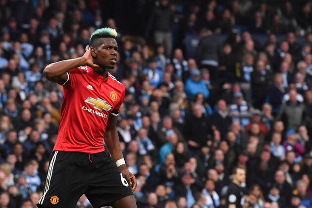 TOPSHOT - Manchester United's French midfielder Paul Pogba celebrates scoring their second goal to equalise 2-2 during the English Premier League football match between Manchester City and Manchester United at the Etihad Stadium in Manchester, north west England, on April 7, 2018. / AFP PHOTO / Ben STANSALL / RESTRICTED TO EDITORIAL USE. No use with unauthorized audio, video, data, fixture lists, club/league logos or 'live' services. Online in-match use limited to 75 images, no video emulation. No use in betting, games or single club/league/player publications.  /         (Photo credit should read BEN STANSALL/AFP/Getty Images)