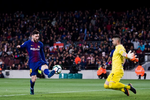 BARCELONA, SPAIN - APRIL 07:  Lionel Messi of FC Barcelona shoots the ball over goalkeeper Ivan Cuellar of CD Leganes and scores his team's third goal during the La Liga match between Barcelona and Leganes at Camp Nou on April 7, 2018 in Barcelona, Spain.  (Photo by Alex Caparros/Getty Images)