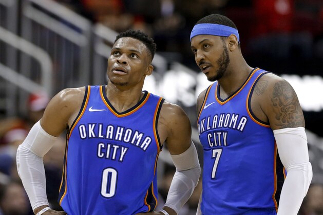 Oklahoma City Thunder guard Russell Westbrook (0) and forward Carmelo Anthony (7) talk during the second half of the team's NBA basketball game against the Houston Rockets on Saturday, April 7, 2018, in Houston. (AP Photo/Michael Wyke)
