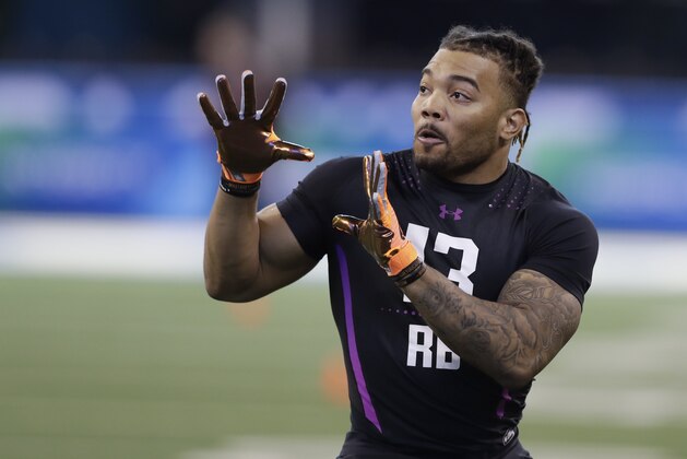 LSU running back Derrius Guice runs a drill during the NFL football scouting combine, Friday, March 2, 2018, in Indianapolis. (AP Photo/Darron Cummings)