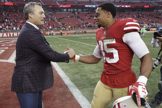 San Francisco 49ers general manager John Lynch, left, greets safety Eric Reid (35) after the 49ers beat the Jacksonville Jaguars in an NFL football game in Santa Clara, Calif., Sunday, Dec. 24, 2017. (AP Photo/Marcio Jose Sanchez)