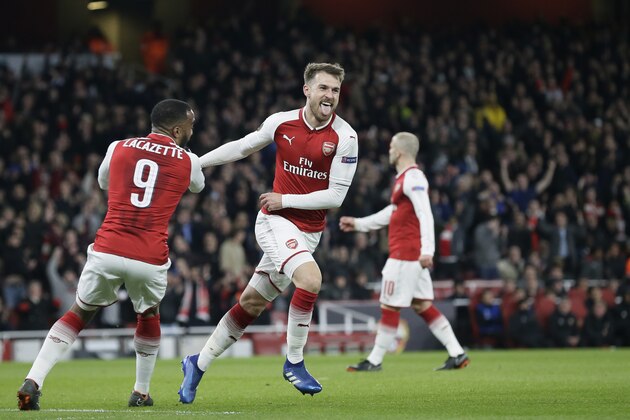 Arsenal's Aaron Ramsey, 2nd left, celebrates with teammate Alexandre Lacazette, left, after scoring his sides third goal during the Europa League quarterfinal, first leg soccer match between Arsenal and CSKA Moscow at the Emirates stadium in London Thursday, April 5, 2018. (AP Photo/Tim Ireland)