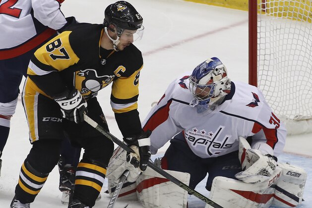 Pittsburgh Penguins' Sidney Crosby (87) can't get his stick on a rebound off Washington Capitals goaltender Philipp Grubauer (31) in the first period of an NHL hockey game in Pittsburgh, Sunday, April 1, 2018. (AP Photo/Gene J. Puskar)