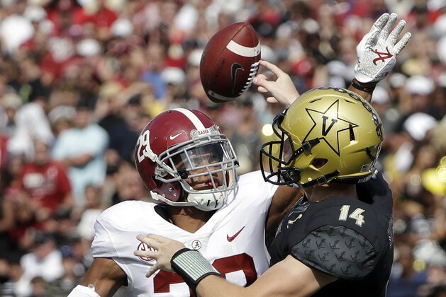 FILE - In this Saturday, Sept. 23, 2017, file photo, Alabama defensive back Minkah Fitzpatrick (29) hits the arm of Vanderbilt quarterback Kyle Shurmur (14) to cause an incomplete pass in the first half of an NCAA college football game in Nashville, Tenn. Goal-oriented since he was 6 and matured beyond his years by a disaster that left his family homeless as he started high school in New Jersey, Fitzpatrick has mastered Nick Saban's process. He sees the game like his coach, leads by example and has become maybe the most versatile defensive player to ever play for Saban. (AP Photo/Mark Humphrey, File)