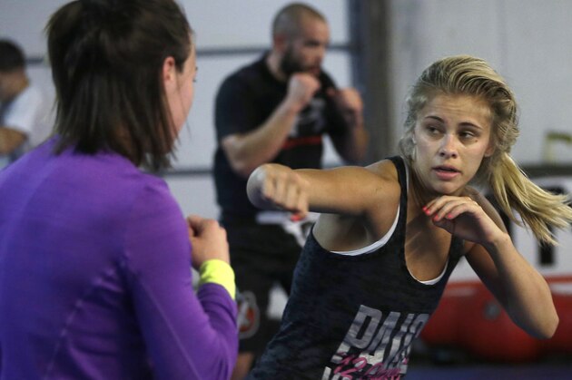 FILE - In this Monday, April 13, 2015, file photo, mixed martial arts fighter Paige VanZant, right, spars with Sarah Jamila at Ultimate Fitness in Sacramento, Calif. VanZant would love to be the next Ronda Rousey in the cage and on the silver screen, but the up-and-coming strawweight UFC fighter realizes she must do plenty of work to catch up to the dominant bantamweight champion. She takes her next step Saturday, Sept. 5, at UFC 191 in Las Vegas against Alex Chambers. (AP Photo/Rich Pedroncelli, File)