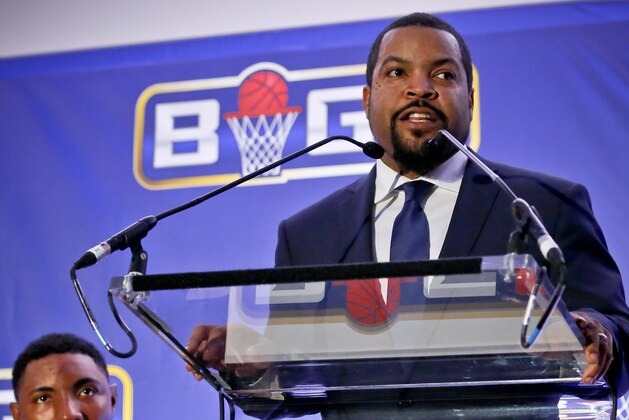 Former NBA player and players union deputy Roger Mason, left, listens as entertainer Ice Cube, right, announces the launch of the BIG3, a new 3-on-3 professional basketball league, in New York, Wednesday, Jan. 11, 2017.  (AP Photo/Bebeto Matthews)