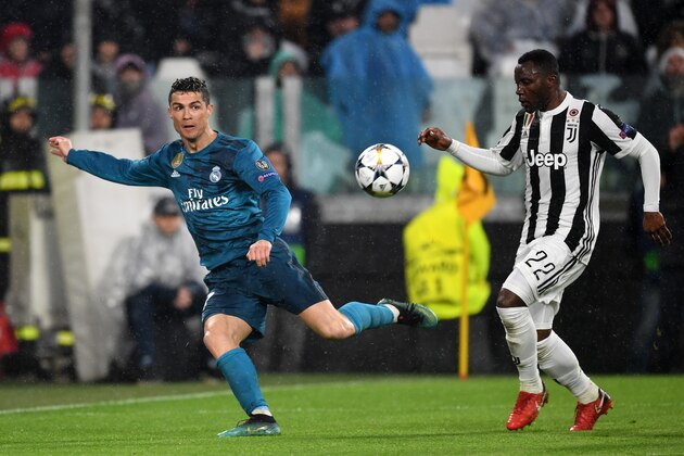 TURIN, ITALY - APRIL 3: Cristiano Ronaldo of Real Madrid and Kwadwo Asamoah of Juventus compete for the ball during the UEFA Champions League Quarter Final first leg between Juventus and Real Madrid at Allianz Stadium on April 3, 2018 in Turin, Italy. (Photo by Etsuo Hara/Getty Images)