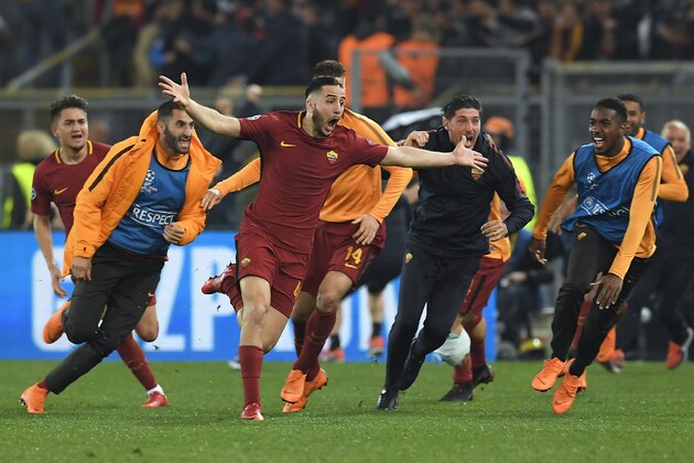 AS Roma's Greek defender Kostas Manolas (C) celebrates after scoring a goal during the UEFA Champions League quarter-final second leg football match between AS Roma and FC Barcelona at the Olympic Stadium in Rome on April 10, 2018. / AFP PHOTO / LLUIS GENE        (Photo credit should read LLUIS GENE/AFP/Getty Images)