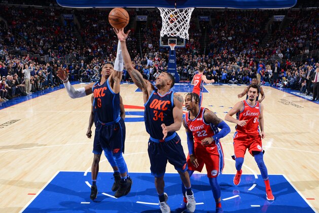 PHILADELPHIA,PA -  DECEMBER 15 : Russell Westbrook #0 and Josh Huestis #34 of the Oklahoma City Thunder grab the rebound against the Philadelphia 76ers at Wells Fargo Center on December 15, 2017 in Philadelphia, Pennsylvania NOTE TO USER: User expressly acknowledges and agrees that, by downloading and/or using this Photograph, user is consenting to the terms and conditions of the Getty Images License Agreement. Mandatory Copyright Notice: Copyright 2017 NBAE (Photo by Jesse D. Garrabrant/NBAE via Getty Images)