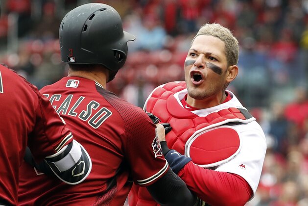 St. Louis Cardinals catcher Yadier Molina, right, is held back by Arizona Diamondbacks' Daniel Descalso while yelling at Diamondbacks manager Torey Lovullo during the second inning of a baseball game Sunday, April 8, 2018, in St. Louis. (AP Photo/Jeff Roberson)