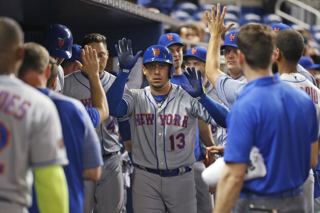 New York Mets' Asdrubal Cabrera (13) celebrates with teammates after hitting a home run during the fourth inning of a baseball game against the Miami Marlins, Tuesday, April 10, 2018, in Miami. (AP Photo/Wilfredo Lee)