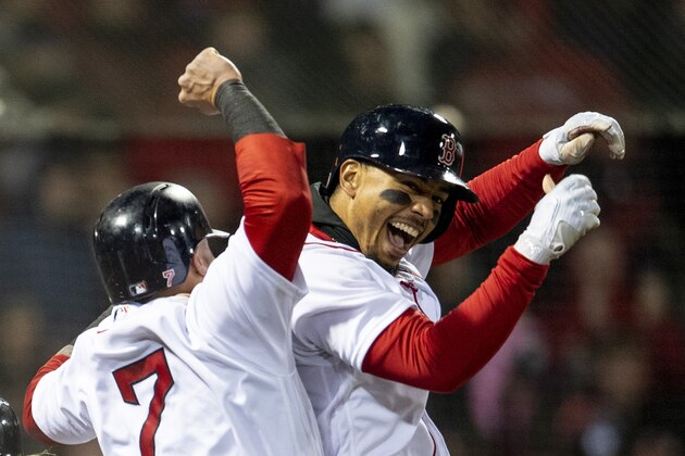 BOSTON, MA - APRIL 10: Mookie Betts #50 of the Boston Red Sox reacts with Christian Vazquez #7 and Brock Holt #12 after hitting a grand slam home run during the sixth inning of a game against the New York Yankees on April 10, 2018 at Fenway Park in Boston, Massachusetts. (Photo by Billie Weiss/Boston Red Sox/Getty Images)