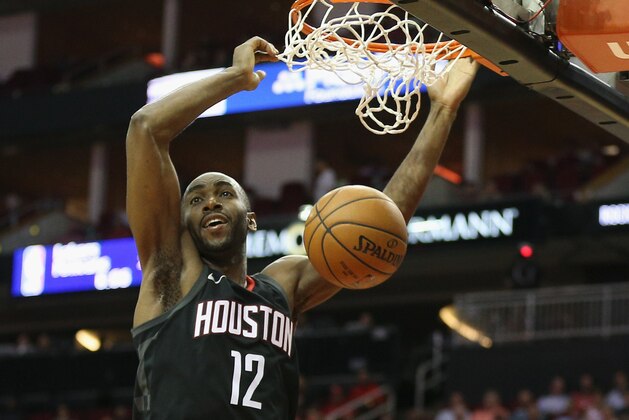 HOUSTON, TX - MARCH 22:  Luc Mbah a Moute #12 of the Houston Rockets dunks against the Detroit Pistons at Toyota Center on March 22, 2018 in Houston, Texas. NOTE TO USER: User expressly acknowledges and agrees that, by downloading and or using this photograph, User is consenting to the terms and conditions of the Getty Images License Agreement.  (Photo by Bob Levey/Getty Images)