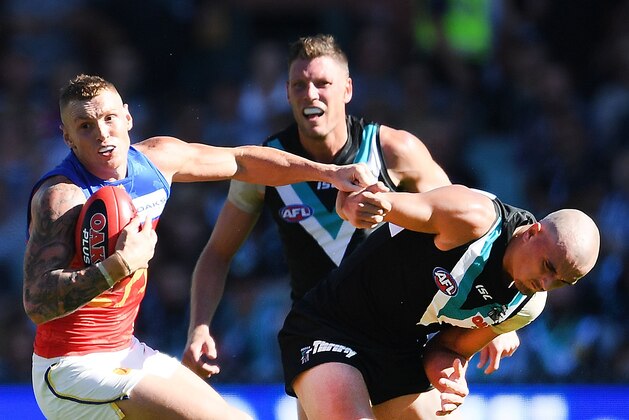ADELAIDE, AUSTRALIA - APRIL 07:  Mitch Robinson of the Lions shrugs off Sam Powell-Pepper of Port Adelaide during the round three AFL match between the Port Adelaide Power and the Brisbane Lions at Adelaide Oval on April 7, 2018 in Adelaide, Australia.  (Photo by Mark Brake/Getty Images)