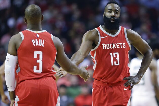 Houston Rockets guard James Harden (13) shakes hands with Chris Paul after a foul during the first half of an NBA basketball game against the Milwaukee Bucks, Saturday, Dec. 16, 2017, in Houston. (AP Photo/Eric Christian Smith)