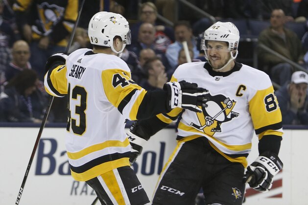 Pittsburgh Penguins' Conor Sheary, left, and Sidney Crosby celebrate their goal against the Columbus Blue Jackets during the third period of an NHL hockey game Thursday, April 5, 2018, in Columbus, Ohio. (AP Photo/Jay LaPrete)