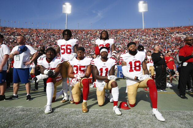 LOS ANGELES, CA - DECEMBER 31: Eli Harold #57, Eric Reid #35, Marquise Goodwin #11 and Louis Murphy #18 of the San Francisco 49ers kneel during the anthem as Reuben Foster #56 and Adrian Colbert #38 stand in solidarty, prior to the game against the Los Angeles Rams at Los Angeles Memorial Coliseum on December 31, 2017 in Los Angeles, California. The 49ers defeated the Rams 34-13. (Photo by Michael Zagaris/San Francisco 49ers/Getty Images)