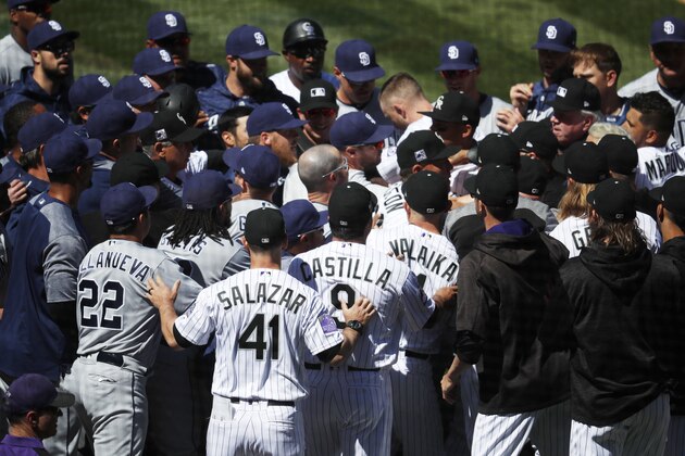 Players from the Colorado Rockies and San Diego Padres scuffle after Colorado's Nolan Arenado was hit by a pitch from Padres starting pitcher Luis Perdomo in the third inning of a baseball game, Wednesday, April 11, 2018, in Denver. (AP Photo/David Zalubowski)
