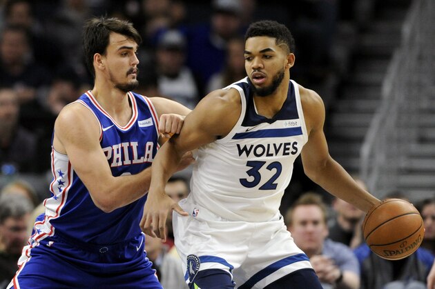 Philadelphia 76ers forward Dario Saric (9), of Croatia, guards Minnesota Timberwolves center Karl-Anthony Towns (32) during the first quarter of an NBA basketball game on Tuesday, Dec. 12, 2017, in Minneapolis. (AP Photo/Hannah Foslien)