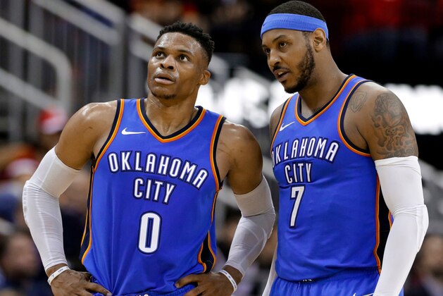 FILE - In this Saturday, April 7, 2018 file photo, Oklahoma City Thunder guard Russell Westbrook (0) and forward Carmelo Anthony (7) talk during the second half of the team's NBA basketball game against the Houston Rockets in Houston. Anthony has been the No. 1 option for whatever team he has played on during most of his basketball career. He knew that wasn't going to be the case when he arrived in Oklahoma City, though it's safe to say things haven't gone as he expected when he signed up to be part the league's next Big Three. (AP Photo/Michael Wyke, File)