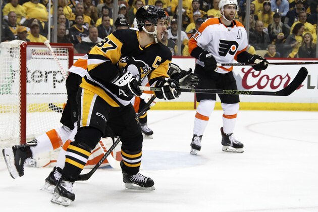 Pittsburgh Penguins' Sidney Crosby (87) redirects a shot past Philadelphia Flyers goaltender Brian Elliott for a goal during the second period in Game 1 of an NHL first-round hockey playoff series in Pittsburgh, Wednesday, April 11, 2018. (AP Photo/Gene J. Puskar)