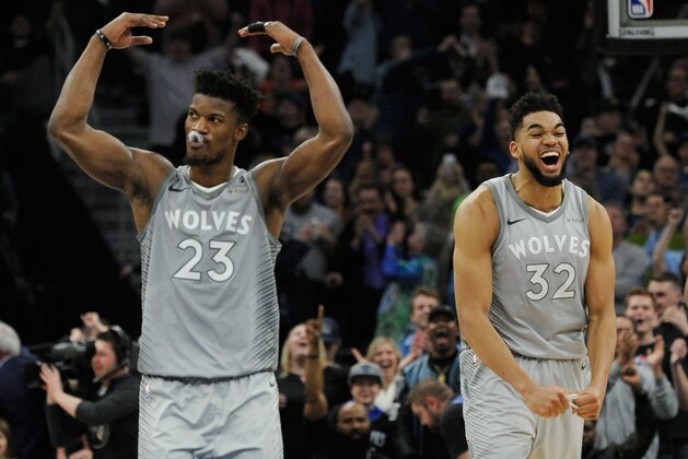 MINNEAPOLIS, MN - APRIL 11: Jimmy Butler #23 and Karl-Anthony Towns #32 of the Minnesota Timberwolves celebrate in the final minute of overtime of the game against the Denver Nuggets on April 11, 2018 at the Target Center in Minneapolis, Minnesota. The Timberwolves defeated the Nuggets 112-106. NOTE TO USER: User expressly acknowledges and agrees that, by downloading and or using this Photograph, user is consenting to the terms and conditions of the Getty Images License Agreement. (Photo by Hannah Foslien/Getty Images)