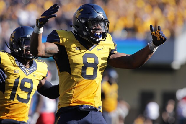 FILE - In this Oct. 14, 2017, file photo, West Virginia safety Kyzir White (8) gestures during the an NCAA college football game against Texas Tech in Morgantown, W.Va. Kyzir White had his team-leading third interception of the season to seal a 46-35 win over Texas Tech on Saturday. He also tied for the team high with nine tackles and forced a fumble. (AP Photo/Raymond Thompson, File)