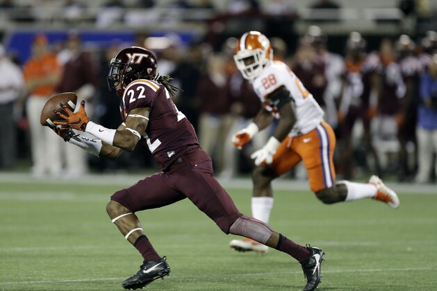 Virginia Tech linebacker Terrell Edmunds (22) makes a catch ahead of Clemson running back Tavien Feaster (28), during the first half of the American Coast Conference championship NCAA college football game, Saturday, Dec. 3, 2016, in Orlando, Fla. (AP Photo/Chris O'Meara)