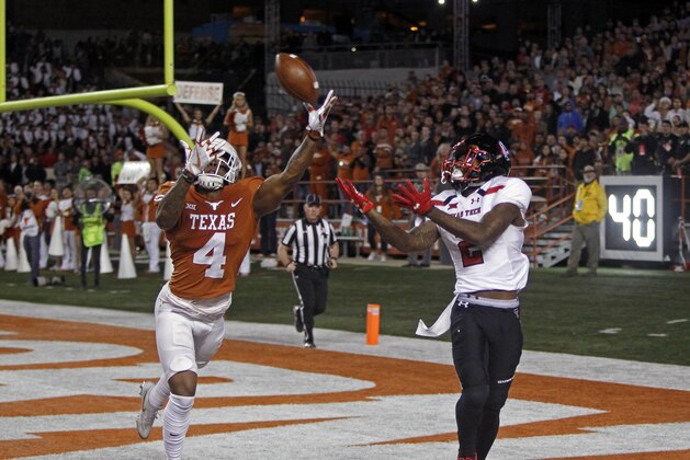 Texas defensive back DeShon Elliott (4) knocks the ball away from Texas Tech receiver Keke Soutee (2) during the second half of an NCAA college football game, Friday, Nov. 24, 2017, in Austin, Texas. Texas Tech won 27-23. (AP Photo/Michael Thomas)