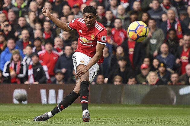 TOPSHOT - Manchester United's English striker Marcus Rashford scores the opening goal during the English Premier League football match between Manchester United and Liverpool at Old Trafford in Manchester, north west England, on March 10, 2018. / AFP PHOTO / Oli SCARFF / RESTRICTED TO EDITORIAL USE. No use with unauthorized audio, video, data, fixture lists, club/league logos or 'live' services. Online in-match use limited to 75 images, no video emulation. No use in betting, games or single club/league/player publications.  /         (Photo credit should read OLI SCARFF/AFP/Getty Images)