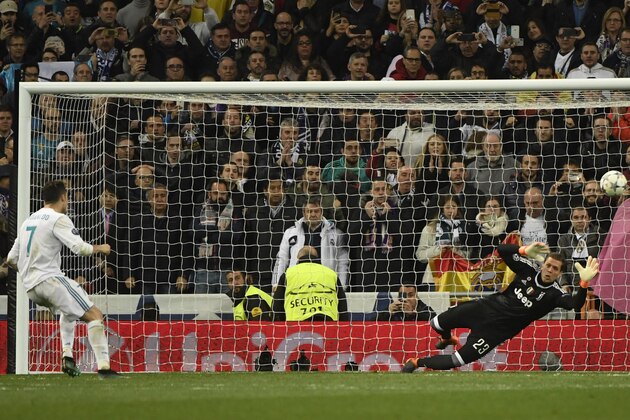 Real Madrid's Portuguese forward Cristiano Ronaldo shoots a penalty kick to score a goal during the UEFA Champions League quarter-final second leg football match between Real Madrid CF and Juventus FC at the Santiago Bernabeu stadium in Madrid on April 11, 2018. / AFP PHOTO / PIERRE-PHILIPPE MARCOU        (Photo credit should read PIERRE-PHILIPPE MARCOU/AFP/Getty Images)