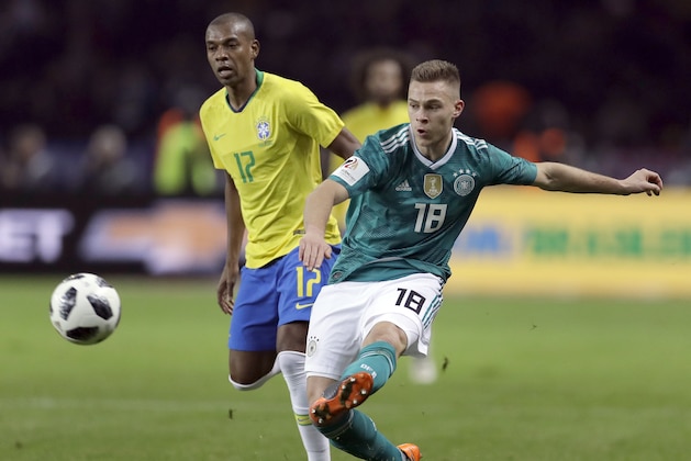 Germany's Joshua Kimmich, front, plays the ball during the international friendly soccer match between Germany and Brazil in Berlin, Germany, Tuesday, March 27, 2018. Brazil defeated Germany by 1-0. (AP Photo/Michael Sohn)