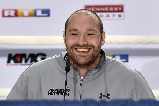 Britain's heavyweight world boxing champion Tyson Fury smiles as he talks to the media during a press conference in Cologne, Germany, Thursday, April 28, 2016. Challenger Wladimir Klitschko of Ukraine is scheduled for a rematch against Fury on Saturday July 9 at the Manchester Arena in Britain. (AP Photo/Martin Meissner)