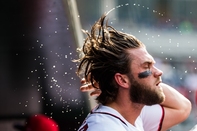 WASHINGTON, DC - JUNE 14:  Bryce Harper #34 of the Washington Nationals wets his hair on a hot day during the game against the Atlanta Braves at Nationals Park on June 14, 2017 in Washington, DC. (Photo by Rob Tringali/SportsChrome/Getty Images)