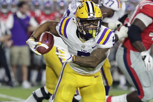 LSU running back Derrius Guice (5) runs through Mississippi defenders for a long gain in the first half of an NCAA college football game in Oxford, Miss., Saturday, Oct. 21, 2017. No. 24 LSU won 40-24. (AP Photo/Rogelio V. Solis)