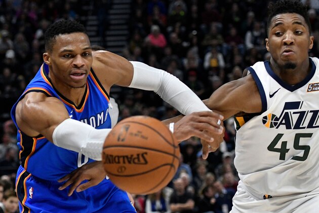 SALT LAKE CITY, UT - DECEMBER 23: Russell Westbrook #0 of the Oklahoma City Thunder and Donovan Mitchell #45 of the Utah Jazz go after the loose ball in the first half at Vivint Smart Home Arena on December 23, 2017 in Salt Lake City, Utah. NOTE TO USER: User expressly acknowledges and agrees that, by downloading and or using this photograph, User is consenting to the terms and conditions of the Getty Images License Agreement. (Photo by Gene Sweeney Jr./Getty Images)