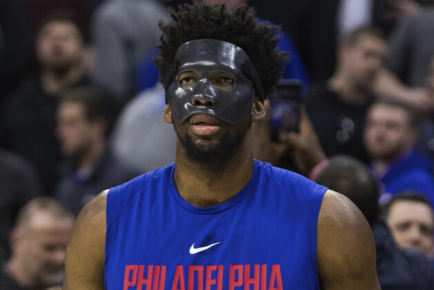 Philadelphia 76ers' Joel Embiid, of Cameroon, looks on while wearing a mask prior to an NBA basketball game against the Milwaukee Bucks, Wednesday, April 11, 2018, in Philadelphia. (AP Photo/Chris Szagola)