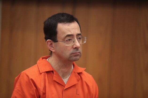 CHARLOTTE, MI - FEBRUARY 05:  Larry Nassar stands as he is sentenced by Judge Janice Cunningham for three counts of criminal sexual assault in Eaton County Circuit Court on February 5, 2018 in Charlotte, Michigan. Nassar has been accused of sexually assaulting more than 150 girls and young women while he was a physician for USA Gymnastics and Michigan State University. Cunningham sentenced Nassar to 40 to 125 years in prison. He is currently serving a 60-year sentence in federal prison for possession of child pornography. Last month a judge in Ingham County, Michigan sentenced Nassar to an 40 to 175 years in prison after he plead guilty to sexually assaulting seven girls.  (Photo by Scott Olson/Getty Images)